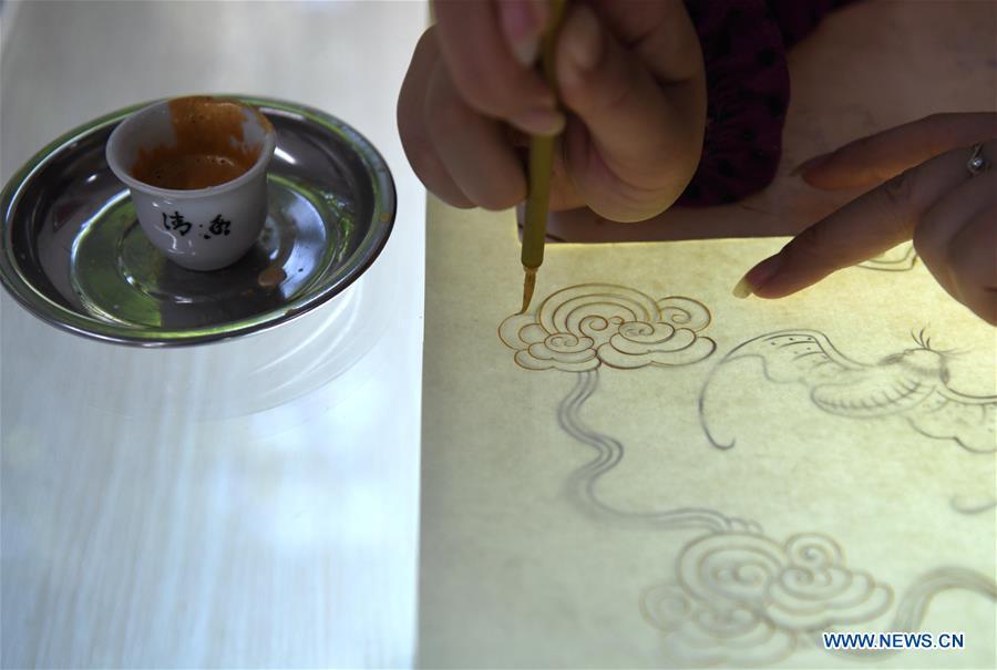 <?php echo strip_tags(addslashes(A worker applies gold paint to a piece of Fenlajian paper at a workshop run by paper artisan Liu Jing in Huanglu Township of Chaohu, east China's Anhui Province, May 23, 2019. Fenlajian is a high-end wax mineral paper which dates back to the Tang dynasty (618-907). For centuries, access to the Fenlajian paper had remained a privilege reserved solely for China's imperial families, due to the costly materials and the set of complicated procedures involved in its making. The techniques in producing this fine writing and painting material even became lost in the late Qing dynasty (1644-1911), until Liu Jing, an Anhui-based paper artisan, managed to revive them through constant trials by the end of the 20th century. Born in a family of paper-makers, Liu now runs a paper workshop dedicated to making Fenlajian and other classical papers while promoting their know-hows. Liu's classical paper processing techniques were listed as a national intangible cultural heritage in 2008, and he himself was named as a national representative inheritor to the aforementioned techniques in 2018. (Xinhua/Liu Junxi))) ?>