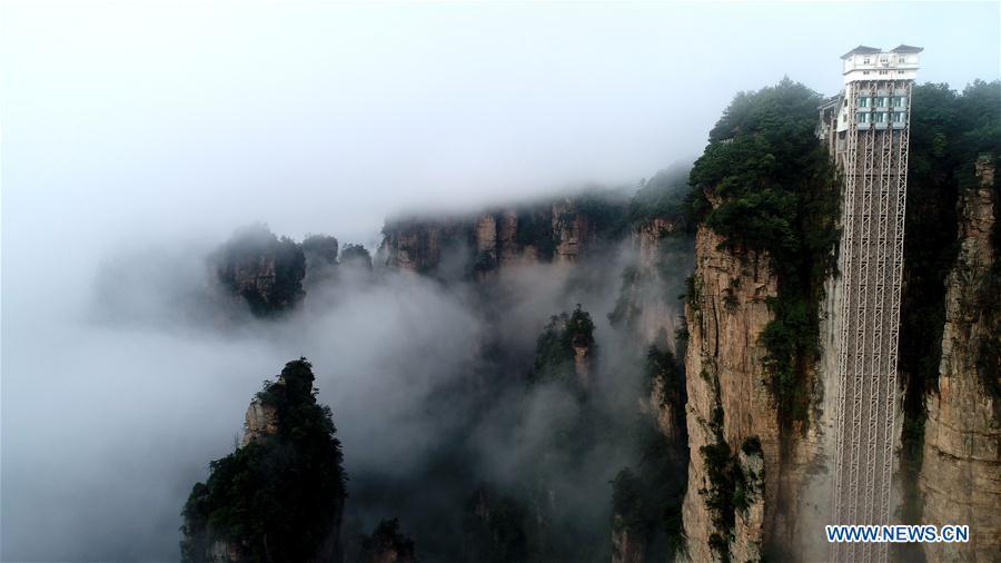 <?php echo strip_tags(addslashes(Aerial photo taken on May 25, 2019 shows the 326-meter-high Bailong Elevator, the world's highest outdoor elevator, shrouded by fog at the Wulingyuan Scenic Area in Zhangjiajie, central China's Hunan Province. (Xinhua/Wu Yongbing))) ?>