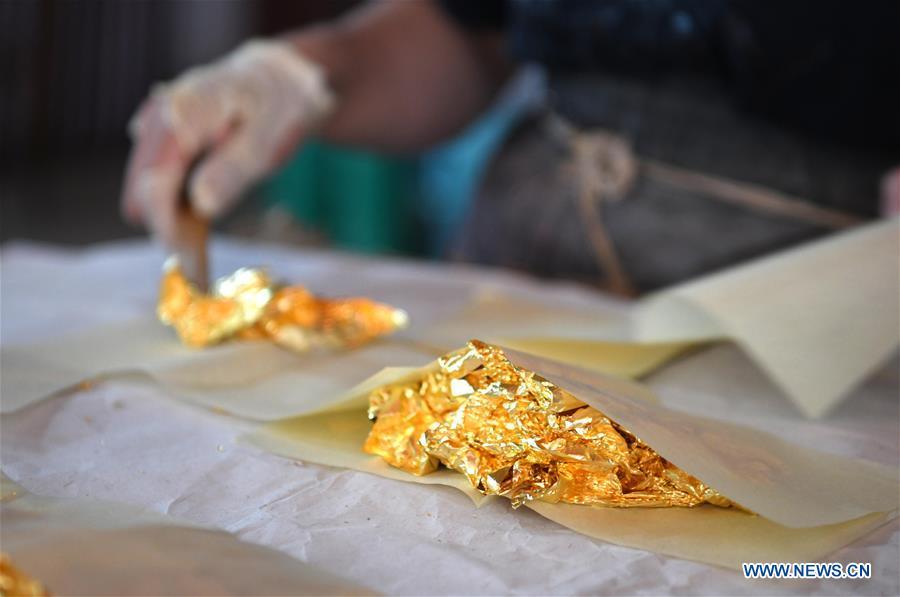 <?php echo strip_tags(addslashes(A worker prepares sheets of gold foil before grinding them into powder to make Fenlajian paper at a workshop run by paper artisan Liu Jing in Huanglu Township of Chaohu, east China's Anhui Province, May 23, 2019. Fenlajian is a high-end wax mineral paper which dates back to the Tang dynasty (618-907). For centuries, access to the Fenlajian paper had remained a privilege reserved solely for China's imperial families, due to the costly materials and the set of complicated procedures involved in its making. The techniques in producing this fine writing and painting material even became lost in the late Qing dynasty (1644-1911), until Liu Jing, an Anhui-based paper artisan, managed to revive them through constant trials by the end of the 20th century. Born in a family of paper-makers, Liu now runs a paper workshop dedicated to making Fenlajian and other classical papers while promoting their know-hows. Liu's classical paper processing techniques were listed as a national intangible cultural heritage in 2008, and he himself was named as a national representative inheritor to the aforementioned techniques in 2018. (Xinhua/Liu Junxi))) ?>