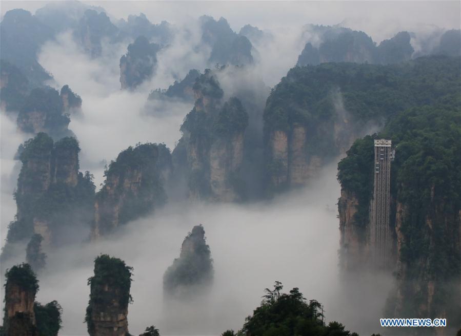 <?php echo strip_tags(addslashes(Aerial photo taken on May 25, 2019 shows the 326-meter-high Bailong Elevator, the world's highest outdoor elevator, shrouded by fog at the Wulingyuan Scenic Area in Zhangjiajie, central China's Hunan Province. (Xinhua/Wu Yongbing))) ?>