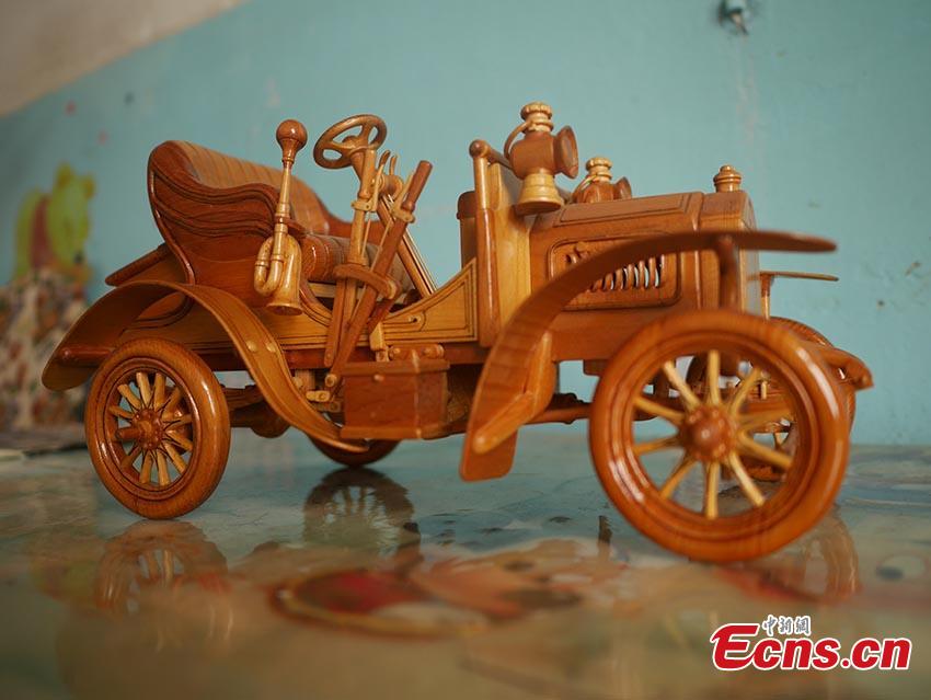 <?php echo strip_tags(addslashes(Chuai Mege shows his hand-made miniature motorcycles carved out of wood in Jilin City, Jilin Province. A former automobile mechanic, the 66-year-old man has been fascinated with making miniature motorcycles for 24 years. He said he usually needs a whole year to complete the making a miniature motorcycle because of his attention to detail and quality. For example, he needs to carve over 700 motorcycle parts including  tires, the dashboard, and even screws. (Photo: China News Service/Cang Yan))) ?>