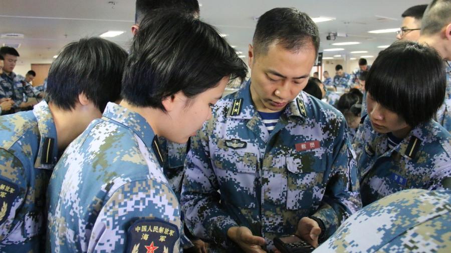 Cadets take their questions to a teacher on board. (Photo provided to chinadaily.com.cn)