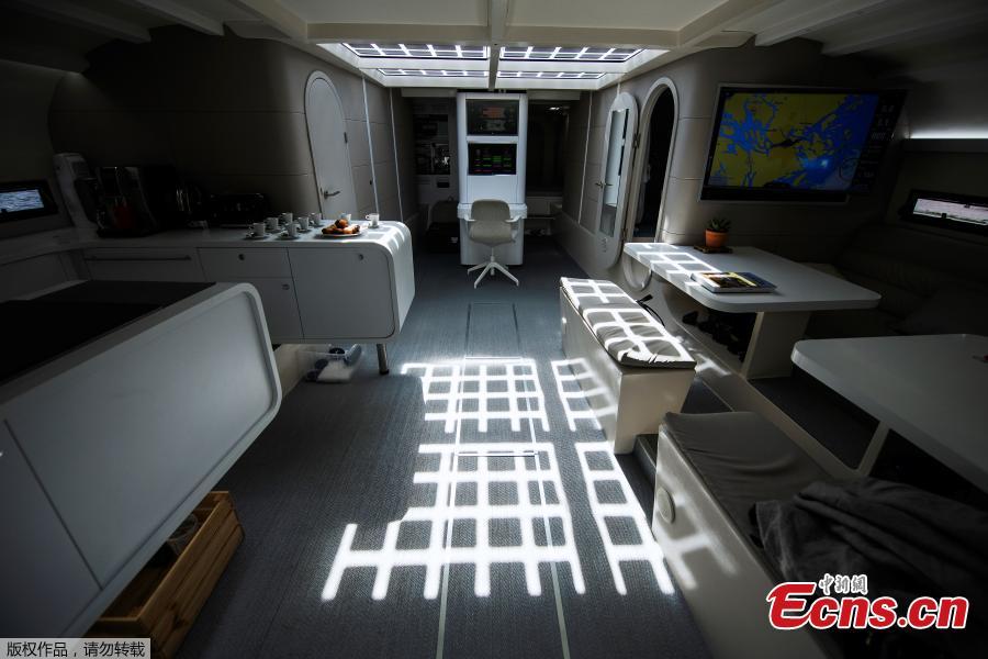 <?php echo strip_tags(addslashes(A picture taken on May 28, 2019 shows the interior of the main cabin onboard the self-energy producing multihull 