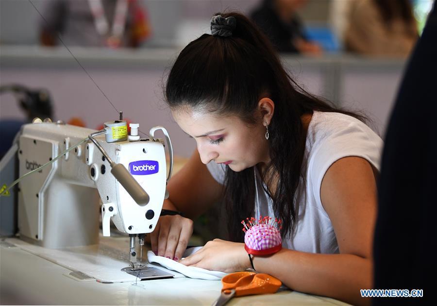 <?php echo strip_tags(addslashes(A contestant participates in the dressmaking competition during the Belt And Road International Skills Competition held in Chongqing International Expo Center in Chongqing, southwest China, May 29, 2019. (Xinhua/Wang Quanchao))) ?>
