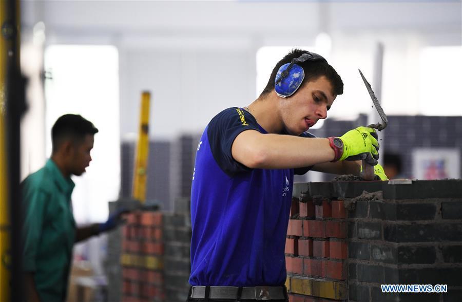 <?php echo strip_tags(addslashes(A contestant participates in the bricklaying competition during the Belt And Road International Skills Competition held in Chongqing International Expo Center in Chongqing, southwest China, May 29, 2019. (Xinhua/Wang Quanchao))) ?>