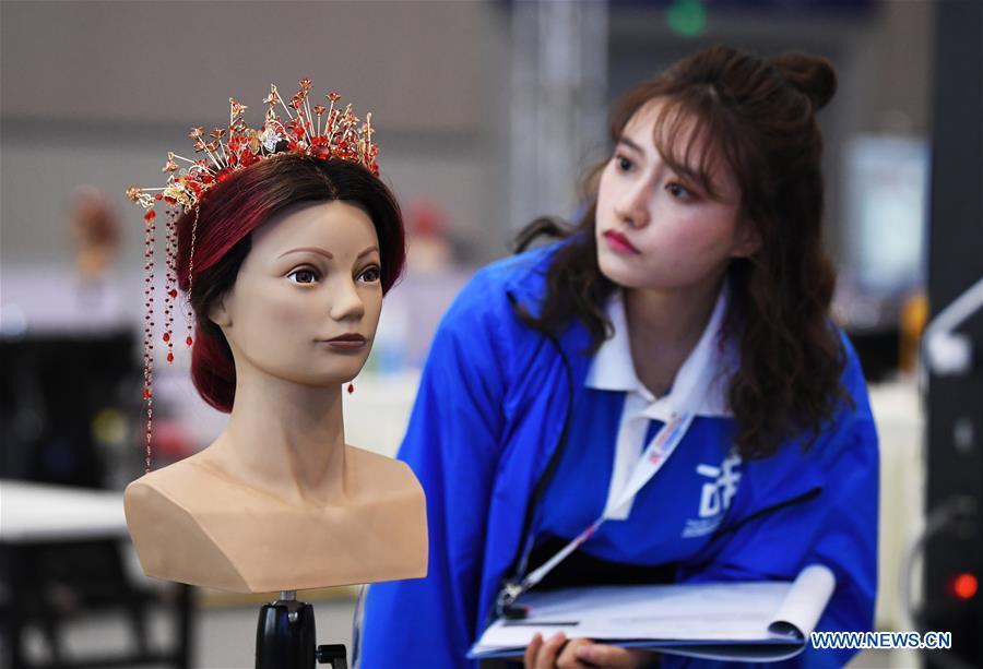 <?php echo strip_tags(addslashes(A contestant participates in the hairdressing competition during the Belt And Road International Skills Competition held in Chongqing International Expo Center in Chongqing, southwest China, May 29, 2019. (Xinhua/Wang Quanchao))) ?>