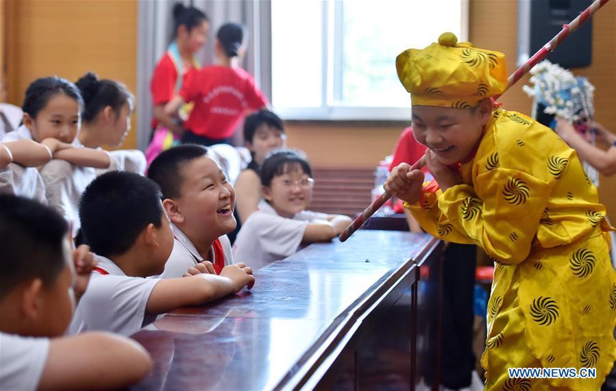 <?php echo strip_tags(addslashes(Students interact with each other during the break of a Peking Opera show in celebration of the upcoming International Children's Day at a primary school in Shijiazhuang City, north China's Hebei Province, May 29, 2019. (Xinhua/Zhang Xiaofeng))) ?>