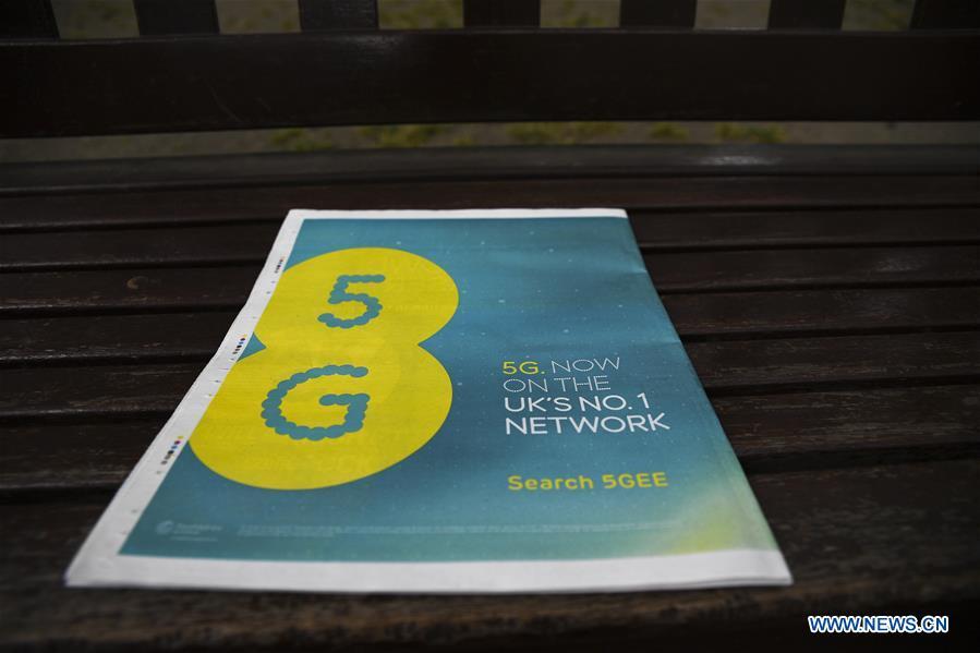 An EE advertisement appears on a newspaper on the day the mobile network operator has officially launched the 5G service in London, Britain, May 30, 2019. Mobile network operator EE said on last Wednesday that it would launch Britain\'s first 5G service in six major cities on May 30th. (Xinhua/Han Yan)