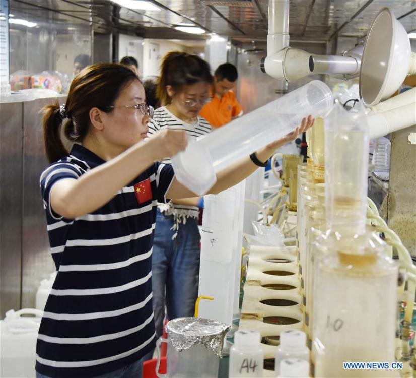 Researchers deal with samples of sea water on China\'s research vessel KEXUE(Science) in the western Pacific Ocean, May 29, 2019. KEXUE is carrying out a 20-day long investigation over a series of seamounts in the south of the Mariana Trench in the western Pacific Ocean. They will focus on biological diversities, ecological systems and biological distributions of the seamounts that they planned to explore. (Xinhua/Zhang Xudong)