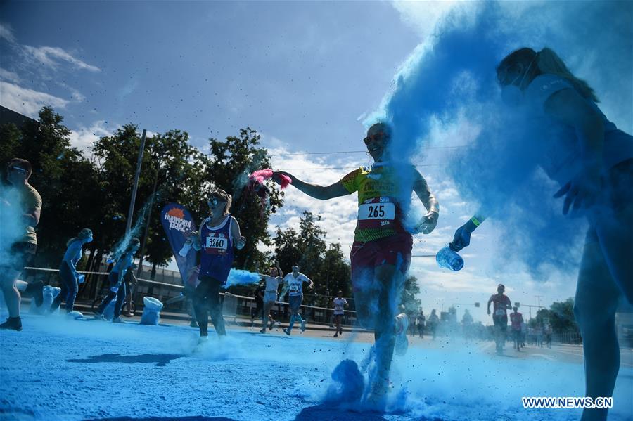 Participants run through colored powder during the annual color run in Moscow, Russia, June 2, 2019. (Xinhua/Evgeny Sinitsyn)