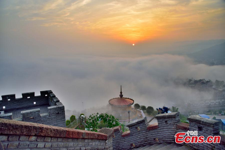 Fog shrouds buildings in the Wine Town, near the Yangtze River, in Fuling District, Chongqing Municipality, June 2, 2019. (Photo: China News Service/Shi Wei)