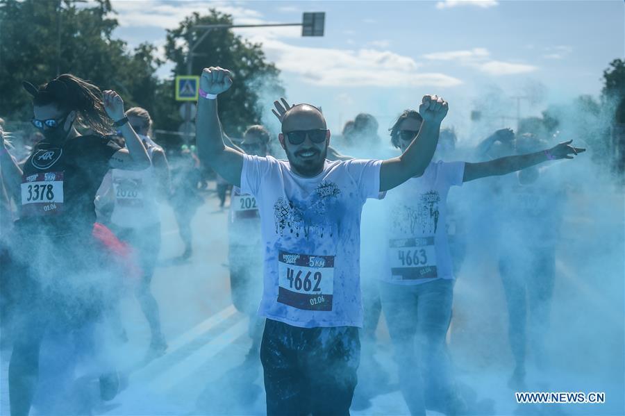 Participants run through colored powder during the annual color run in Moscow, Russia, June 2, 2019. (Xinhua/Evgeny Sinitsyn)