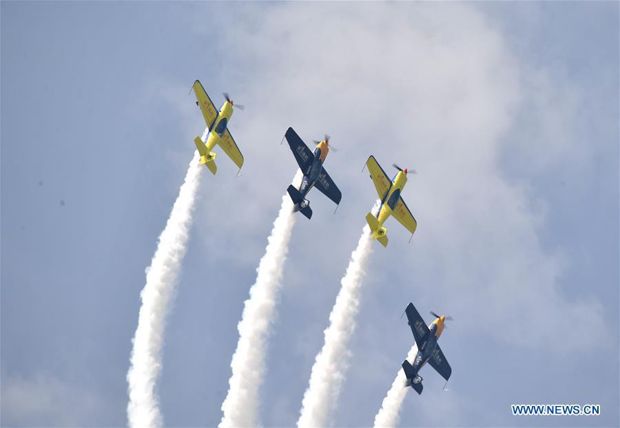 Enthusiasts in air sports give an aerobatic show during the opening of the 11th Air Sports Culture and Tourism Festival in Anyang, central China\'s Henan Province, June 3, 2019. The event kicked off Monday in the city of Anyang, attracting air sports fans from home and abroad. (Xinhua/Li Jianan)