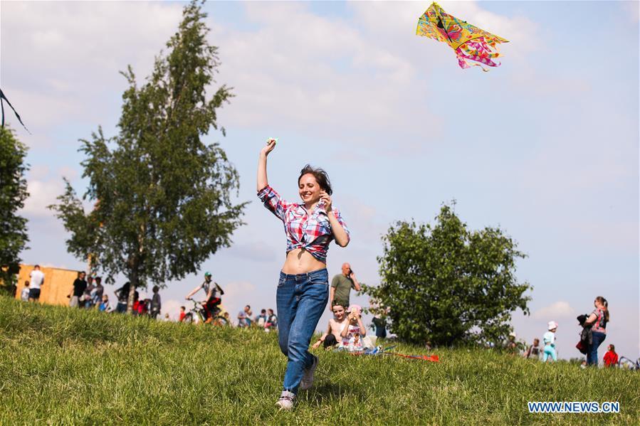 A woman flies a kite during the Motley Sky festival in Moscow, Russia, on May 26, 2019. The Motley Sky festival was held in Moscow from May 25 to 26. (Xinhua/Maxim Chernavsky)