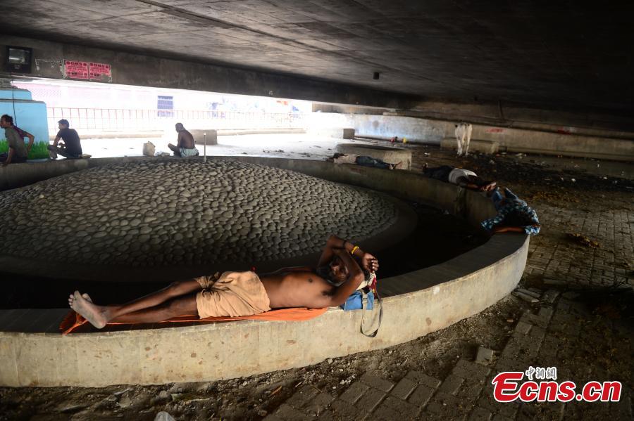 <?php echo strip_tags(addslashes(An Indian man rests under a bridge during a hot summer afternoon in Allahabad on June 2, 2019. Temperatures passed 50 degrees Celsius in northern India as an unrelenting heatwave triggered warnings of water shortages and heatstroke.(Photo/IC))) ?>