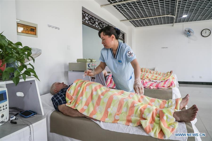 <?php echo strip_tags(addslashes(A Russian patient receives physiotherapy at Tanggangzi Hospital in Anshan, northeast China's Liaoning Province, June 4, 2019. Featured with traditional Chinese medicine therapy, Tanggangzi Hospital has attracted many Russian patients who come here to receive rehabilitation treatments, such as acupuncture, physiotherapy, cephalic magnet therapy. The hospital received more than 6,000 Russian patients in one year at the peak. (Xinhua/Pan Yulong))) ?>