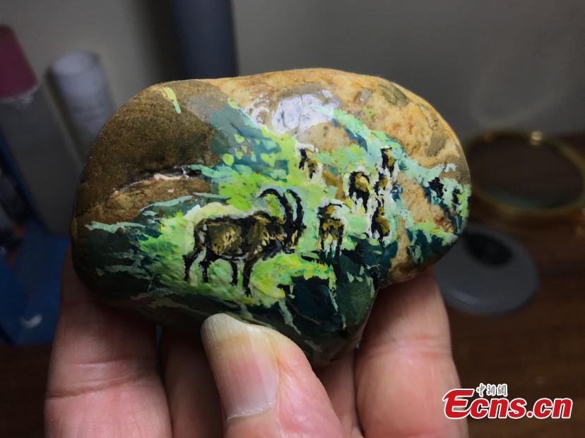 <?php echo strip_tags(addslashes(Zhang Yulin shows a paintings on a stone.Zhang, 81, from southwest China’s Chongqing municipality, collects stones from the Yangtze River banks and turns them into artworks with paintings.  (Photo: China News Service/Xiao Jiangchuan))) ?>