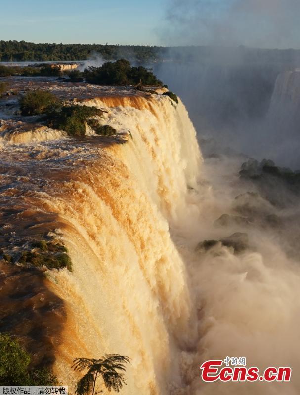 <?php echo strip_tags(addslashes(Picture of the Iguacu falls -considered as one of the largest waterfalls in the world- as seen from the Brazilian side on the border with Argentina, near Foz do Iguacu, on June 4, 2019. The quantity of water falling from the Iguacu falls at the border between Argentina and Brazil has doubled these last few days following heavy rains in the region. While the average flow rate of the falls is usually 1,5 million liters of water per second, the currently rate is at 3 million. (Photo/Agencies))) ?>
