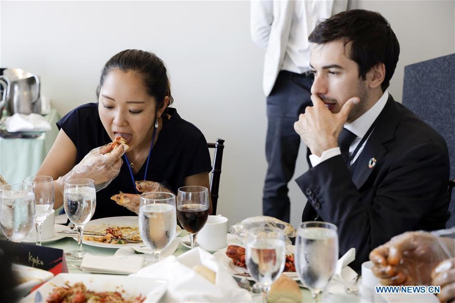 People eat crayfish during the Qianjiang crayfish tasting party at the United Nations headquarters in New York, June 4, 2019. Crayfish, a rarity in Western diet but a favorite of Chinese foodies, on Tuesday made its debut at the UN Delegates Dining Room. Hosted by the city government of Qianjiang, a major producer of crayfish in central China, the tasting party was graced by officials from the UN headquarters, the World Food Programme, the UN Democracy Fund as well as UN diplomats, including representatives from the Dominican and Sri Lankan missions. (Xinhua/Li Muzi)