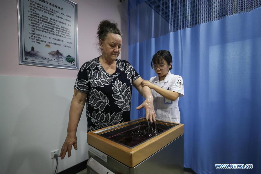<?php echo strip_tags(addslashes(A Russian patient receives wax therapy at Tanggangzi Hospital in Anshan, northeast China's Liaoning Province, June 4, 2019. Featured with traditional Chinese medicine therapy, Tanggangzi Hospital has attracted many Russian patients who come here to receive rehabilitation treatments, such as acupuncture, physiotherapy, cephalic magnet therapy. The hospital received more than 6,000 Russian patients in one year at the peak. (Xinhua/Pan Yulong))) ?>