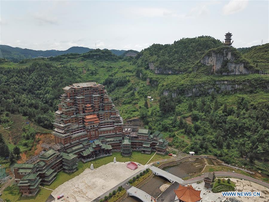 Aerial photo taken on June 7, 2019 shows a wooden building of Shui ethnic group in Yingshan Town of Dushan County, southwest China\'s Guizhou Province. The 24-story, 99.9-meter-high traditional Shui-style wooden building in Dushan is of \