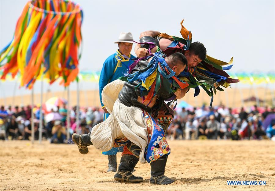 <?php echo strip_tags(addslashes(Participants take part in a wrestling contest during a desert Nadam Fair held in Naiman Banner, Tongliao City, north China's Inner Mongolia Autonomous Region, June 10, 2019. (Xinhua/Peng Yuan))) ?>
