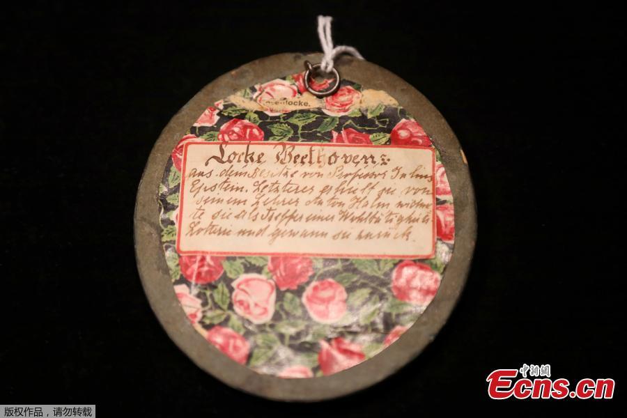 <?php echo strip_tags(addslashes(The reverse of the frame holding a lock of German composer Ludwig van Beethoven's hair is seen on display ahead of a Sotheby's auction, in London, Britain June 10, 2019.(Photo/Agencies))) ?>
