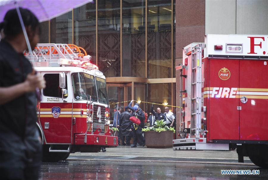 <?php echo strip_tags(addslashes(Rescuers and police officers walk out of the building where a helicopter crashed in Manhattan, New York, the United States, June 10, 2019. One person was killed after a helicopter crashed onto the roof of a skyscraper in Midtown Manhattan of New York City Monday afternoon, according to media reports. (Xinhua/Wang Ying))) ?>