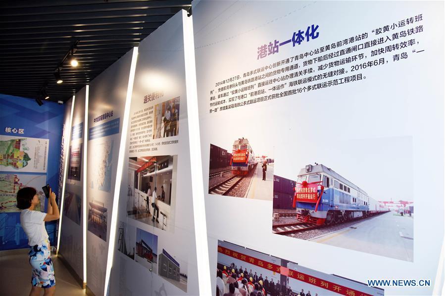 People visit an exhibition hall of the Qingdao multimodal transportation center at a demonstration zone for China-SCO local economic and trade cooperation in Jiaozhou City, east China\'s Shandong Province, on June 12, 2019. (Xinhua/Li Ziheng)