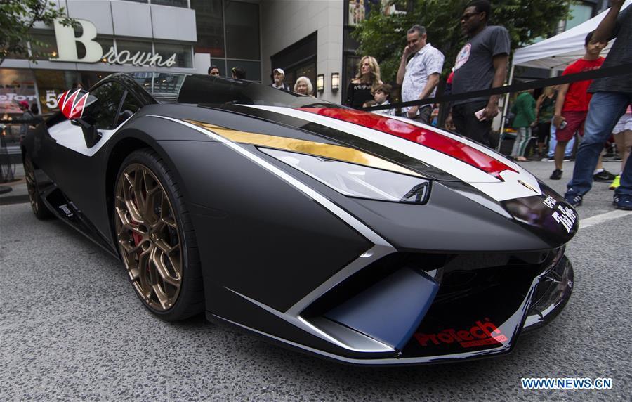 <?php echo strip_tags(addslashes(People visit the 2019 Yorkville Exotic Car Show in Toronto, Canada, June 16, 2019. More than 110 classic and exotic cars were displayed at the annual Father's Day event on Sunday, attracting tens of thousands of visitors. (Xinhua/Zou Zheng))) ?>