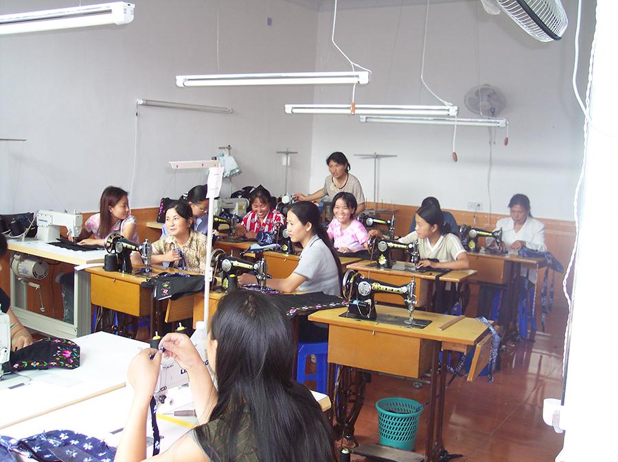 Seamstresses work at the Shenani workshop in 2004.  (Photo provided to chinadaily.com.cn)