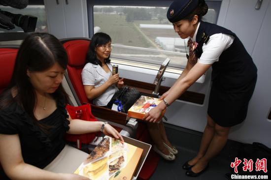 A conductor served in the Beijing-Shanghai high-speed train during the official trip for members of the media June 27, 2011.