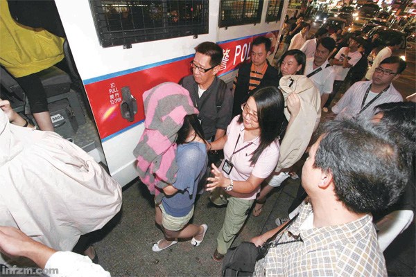 Girls are taken away during a crackdown on compensated dating by Hong Kong police. 