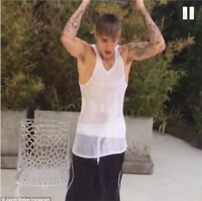 Canadian singer Justin Bieber pours a pot of ice water on himself in a video posted on his Instagram account.