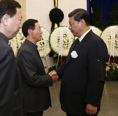 Chinese President Xi Jinping (R, front) shakes hands with a family member of Zhang Zhen, former vice chairman of China's Central Military Commission, during Zhang's funeral at the Babaoshan Revolutionary Cemetery in Beijing, capital of China, Sept. 9, 2015. (Photo: Xinhua/Ju Peng)
