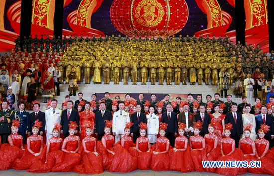 Chinese President Hu Jintao and other members of the Standing Committee of the Political Bureau of the Communist Party of China (CPC) Central Committee, pose for a group photo with performers after an