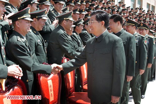 Chinese President Hu Jintao (R, front), who is also chairman of the Central Military Commission, meets with delegates to a conference of Communist Party of China (CPC) members in the Beijing Military Area Command in Beijing, capital of China, May 23, 2012. [Xinhua]