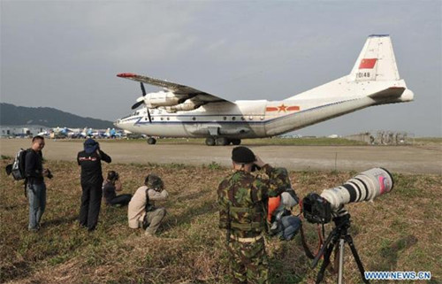 Photographers take photo of a transport aircraft from China Air Force during the 9th China International Aviation and Aerospace Exhibition in Zhuhai, south China's Guangdong Province, Nov. 11, 2012. The exhibition has attracted a large number of photograghers. Some of them are from media, some are from aviation industry corporations and others are big fans of aviation. (Xinhua/Yang Guang)  