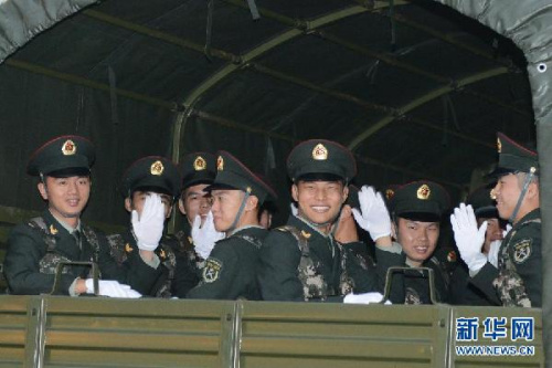 The soldiers who will leave Macao after the rotation bid farewell on a military motor lorry on the early morning of Nov. 20, 2012. The Macao Garrison of the Chinese Peoples Liberation Army (PLA) successfully finished the 13th rotation yesterday morning. (Xinhua/Zhang Jinjia)