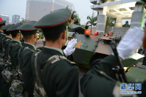 Soldiers of the PLA Macao Garrison line up on both sides of the road to see off the troops who will leave Macao after the rotation on the early morning of Nov. 20, 2012. The Macao Garrison of the Chinese Peoples Liberation Army (PLA) successfully finished the 13th rotation yesterday morning. (Xinhua/Zhang Jinjia)