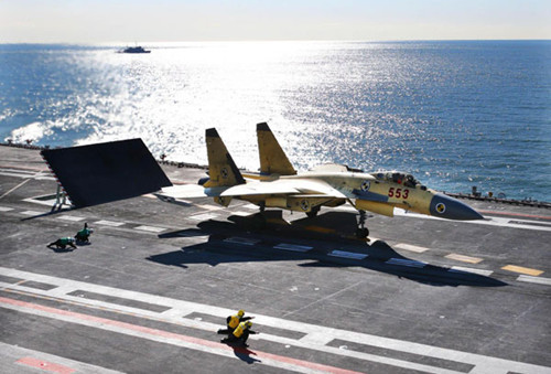 A carrier-borne J-15 fighter jet prepares to take off from China's first aircraft carrier, the Liaoning. After its delivery to the People's Liberation Army (PLA) Navy on September 25, the aircraft carrier has undergone a series of sailing and technological tests, including the flight of the carrier-borne J-15, naval sources said. Designed by and made in China, the J-15 is able to carry multi-type anti-ship, air-to-air and air-to-ground missiles, as well as precision-guided bombs. [Undated photo/Xinhua]