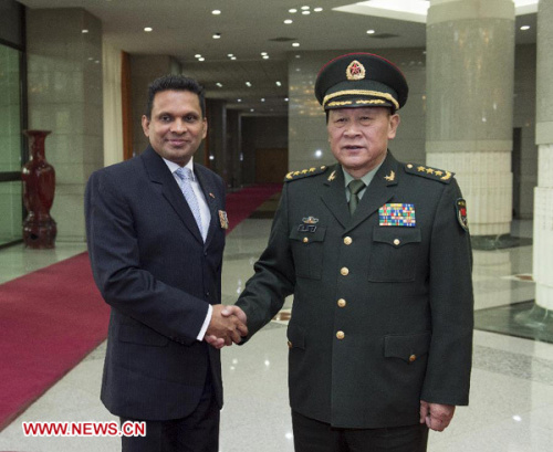 Chinese Defense Minister Liang Guanglie (R) shakes hands with Mohamed Nazim, the Maldives' minister of defense and national security, in Beijing, capital of China, Dec. 11, 2012. (Xinhua/Wang Ye)