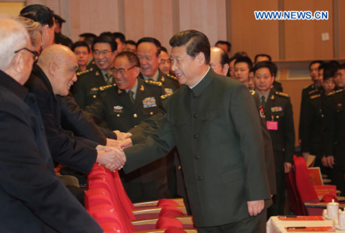 Xi Jinping (R, front), general secretary of the Central Committee of the Communist Party of China (CPC) and also chairman of the CPC Central Military Commission, extends Spring Festival greetings to military veterans and ex-officers at a festive art perfo