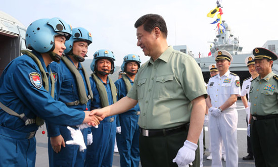 President Xi Jinping greets naval helicopter pilots onboard the vessel Jinggangshan during his visit to the PLA navy in Sanya, Hainan province, on Tuesday. Photo by Li Gang / Xinhua 