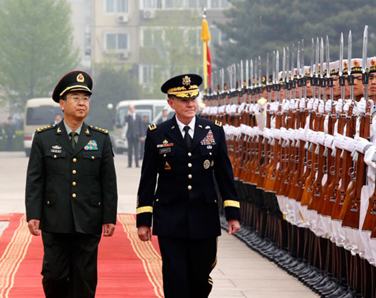 Fang Fenghui (left), chief of General Staff of the People's Liberation Army, welcomes Martin Dempsey, chairman of the US Joint Chiefs of Staff, in Beijing on Monday. Kuang Linhua / China Daily
