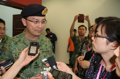 The picture shows that a Singaporean officer attends a press interview. (Xinhua/Wang Jingguo)