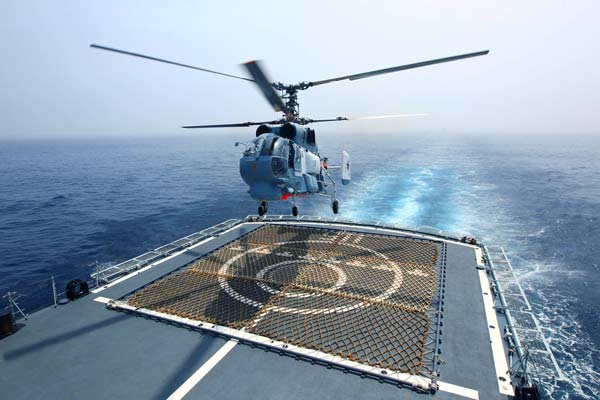 A Russian Ka-27 ship-borne helicopter takes off from the Chinese guided missile destroyer Shenyang on Tuesday during the Joint Sea 2013 exercise. Zha Chunming / Xinhua