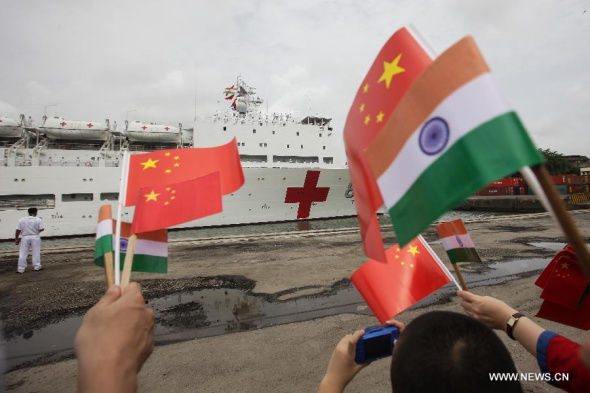 People welcome the Chinese People's Liberation Army Navy hospital ship Peace Ark in Bombay Port in India, Aug. 6, 2013. The Chinese Navy Peace Ark hospital ship, conducting the Mission Harmony-2013, arrived in Bombay Port on Tuesday for a six-day visit . (Xinhua/Zheng Huansong)
