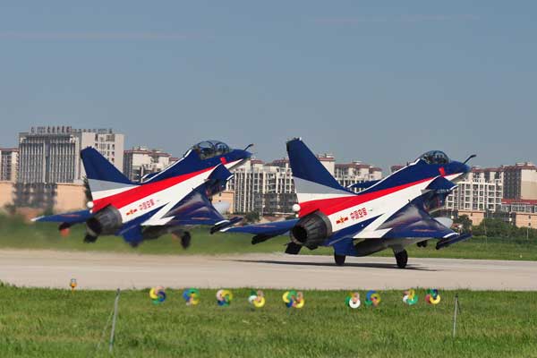 Two J-10 fighters with the PLA August 1st Air Demonstration Team take off from an airport in northern China on Sunday en route to the MAKS 2013 International Air Show. The team will fly in its first overseas performance in its 51-year existence. Zhang Pengyan / FOR CHINA DAILY