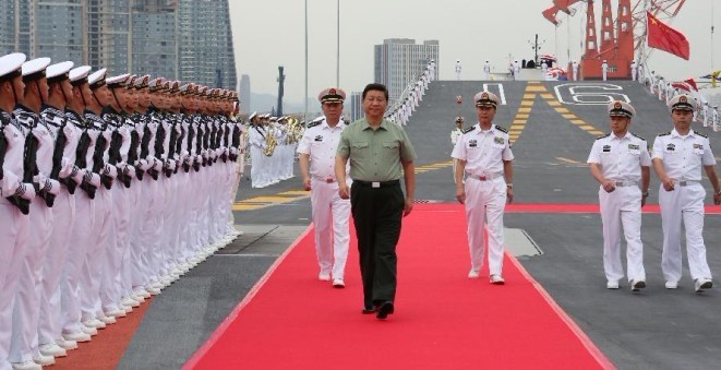 Chinese President Xi Jinping (C front), who is also the chairman of the Central Military Commission and general secretary of the Communist Party of China Central Committee, reviews an honor guard on the aircraft carrier, the Liaoning, in northeast China's Liaoning Province, Aug. 28, 2013. Xi visited the Shenyang military theater of operations before attending the Saturday opening ceremony of the 12th National Games in Shenyang. (Xinhua/Li Gang) 